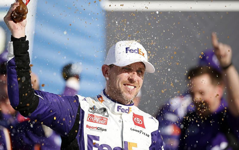 Denny Hamlin celebrates after winning a NASCAR Cup Series auto race at Kansas Speedway in Kansas City, Kan., Sunday, May 7, 2023. (AP Photo/Colin E. Braley)
