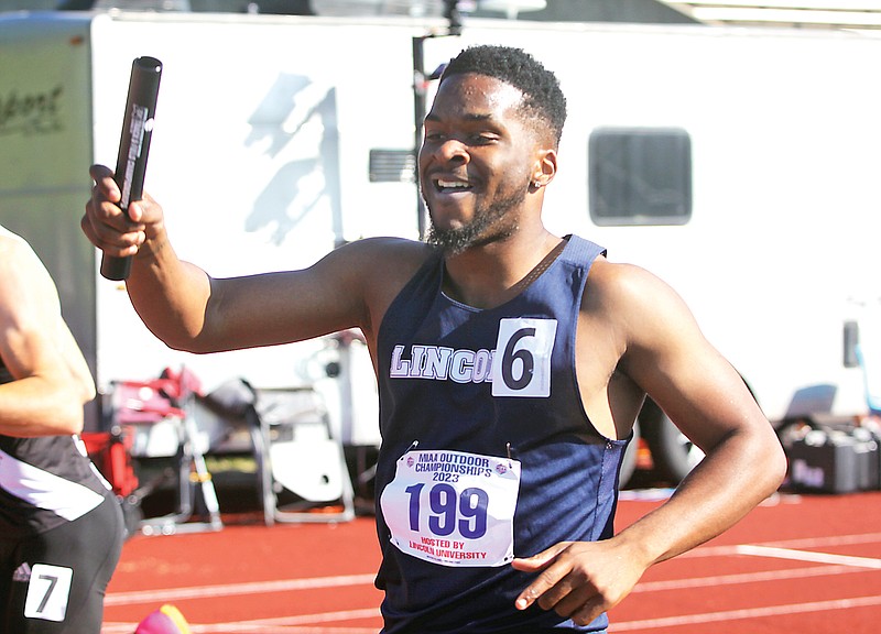 Lincoln’s Reuben Nichols smiles after he crosses the finish line to win the men’s 4x400-meter relay for the Blue Tigers during the MIAA outdoor track and field championships Sunday at Dwight T. Reed Stadium. (Greg Jackson/News Tribune)
