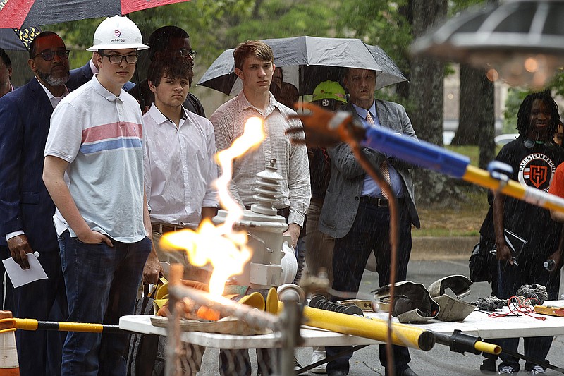 Joe T. Robinson High School students Bryce Smith (from left), Ayden Merritt and Noah Fox watch an electricity demonstration at the Entergy Arkansas building in west Little Rock on Wednesday. Entergy announced a partnership with Robinson and Little Rock Hall STEAM Magnet high schools on Wednesday.
(Arkansas Democrat-Gazette/Thomas Metthe)