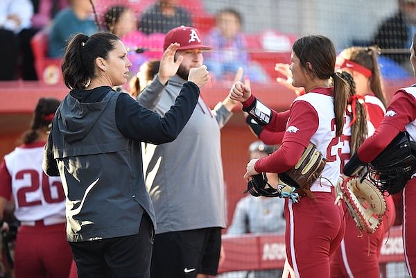 Arkansas coach Courtney Deifel congratulates starter Hannah Camenzind Monday, May 1, 2023, during the Razorbacks’ 2-0 win over Tennessee at Bogle Park in Fayetteville.