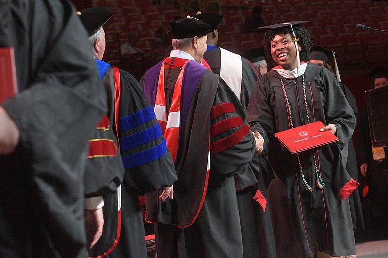 Kennedy Fuller (right) receives her degree on Saturday May 13 2023 at University of Arkansas, Fayetteville, commencement. Go to nwaonline.com/photos for today's photo gallery..(NWA Democrat-Gazette/Flip Putthoff)