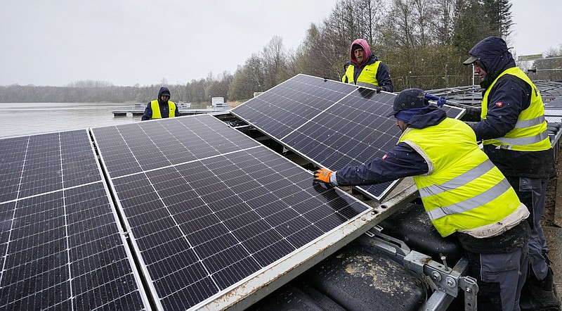 FILE - Solar panels are installed at a floating photovoltaic plant on a lake in Haltern, Germany, Friday, April 1, 2022. Floating solar panel farms are attractive not just for their clean power and lack of a land footprint, but because they also conserve water by preventing evaporation. (AP Photo/Martin Meissner, File)