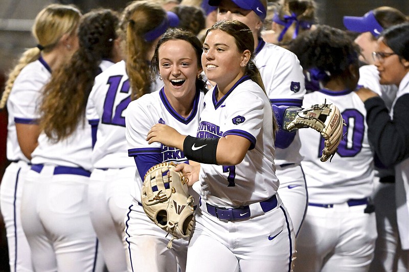 Central Arkansas players Kylie Griffin (left) and McKayla Betts (right) celebrate with their teammates after defeating Arkansas 2-1 during an NCAA softball game in Fayetteville in this March 6, 2023 file photo. (AP/Michael Woods)