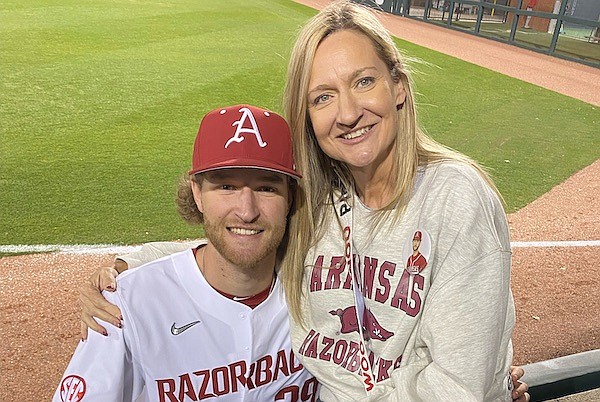 Arkansas pitcher Hunter Hollan (left) and his mother Kimberly pose after a 2023 game in Fayetteville.