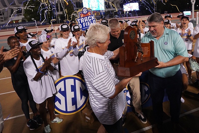 Arkansas coach Lance Harter receives the SEC Outdoor Track and Field Championship trophy on May 13, 2023, in Baton Rouge, La.