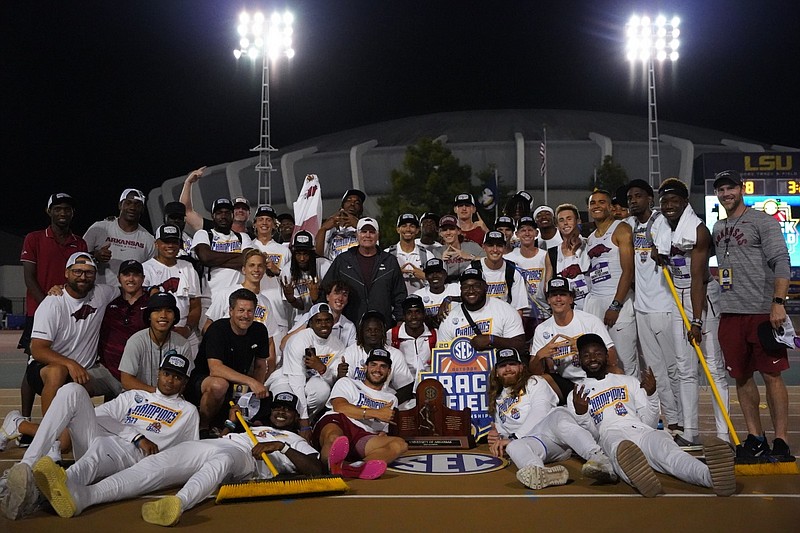Arkansas coach Chris Bucknam celebrates with the Razorbacks after winning the SEC Outdoor Track and Field Championship in Baton Rouge, La., on May 13, 2023.