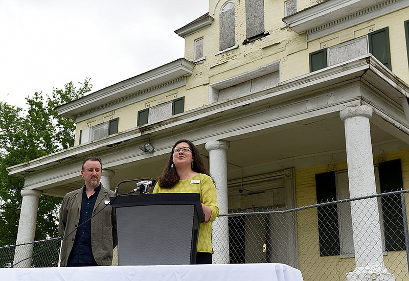 Rachel Patton, executive director of Preserve Arkansas, talks about Arkansas’ most endangered places as Tim Maddox, a Preserve Arkansas board member, looks on at the William Woodruff House in Little Rock on Wednesday during the announcement of this year’s endangered places list.
(Arkansas Democrat-Gazette/Staci Vandagriff)