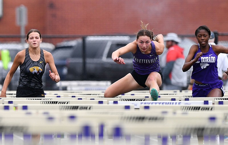 Fayetteville’s Julia Gunnell (center) clears a hurdle during the 100-meter hurdles Wednesday in the Arkansas state high school heptathlon competition at Ramay Junior High School in Fayetteville. More photos at arkansasonline.com/518seven10/
(NWA Democrat-Gazette/Andy Shupe)