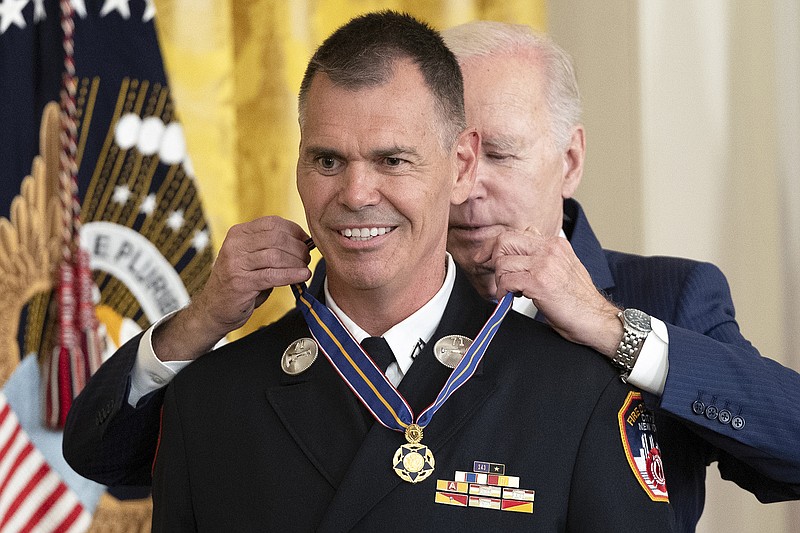 President Joe Biden presents the Medal of Valor to Lt. Jason Hickey of the New York City Fire Department during Wednesday’s ceremony inside the White House. Hickey jumped in the Harlem River to save a man from drowning.
(The New York Times/Tom Brenner)