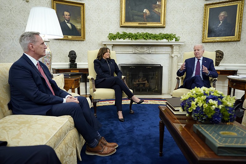 Speaker of the House Kevin McCarthy of Calif., left, and Vice President Kamala Harris listen as President Joe Biden speaks during a meeting with Congressional leaders in the Oval Office of the White House, Tuesday, May 16, 2023, in Washington. (AP Photo/Evan Vucci)
