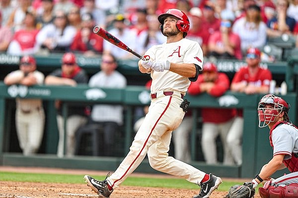 Arkansas left fielder Jared Wegner (11) hits a go-ahead home run Sunday, April 2, 2023, during the fifth inning of the Razorbacks’ 5-4 series-clinching win over Alabama at Baum-Walker Stadium in Fayetteville.
