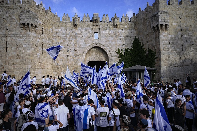 Israelis wave national flags during a march marking Jerusalem Day on Thursday in front of the Damascus Gate of Jerusalem’s Old City. More photos at arkansasonline.com/519oldcity/.
(AP/Ohad Zwigenberg)