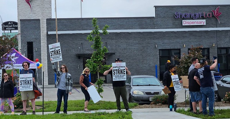 Employees and supporters working to organize a union at Shangri La South dispensary in Columbia, Mo., picket Tuesday, May 16, 2023, outside the store. (Rudi Keller/Missouri Independent photo)
