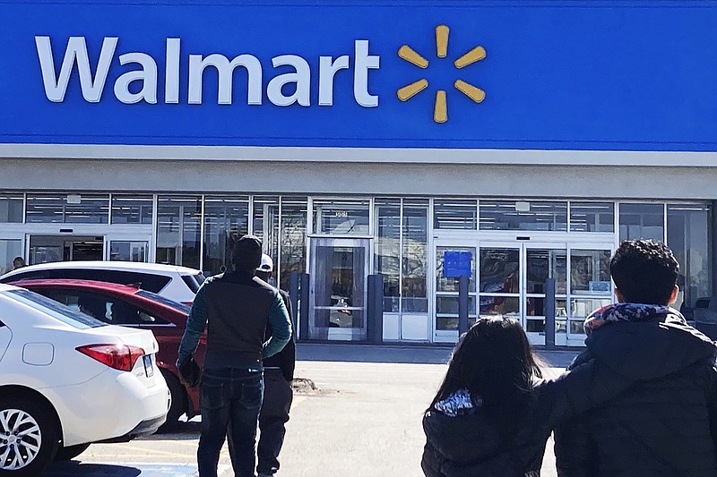 Shoppers walk to a Walmart in Vernon Hills, Ill., Tuesday, March 28, 2023. (AP Photo/Nam Y. Huh)