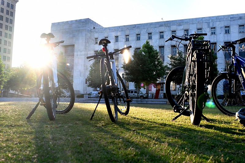 Staff Photo by Robin Rudd / The sun rises behind bicycles parked at Miller Park during the National Bike to Work Day celebration.  Outdoor Chattanooga held a city-wide celebration of National Bike to Work Day at Miller Park on May 19, 2023.