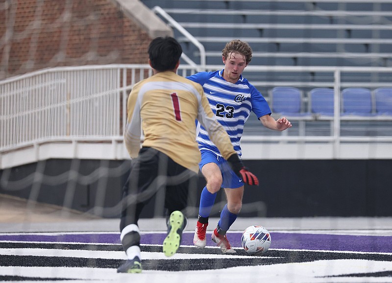 Conway’s Will Childers (23) prepares to take a shot on goal while defended by Springdale goalkeeper Herman Ico during the Class 6A state boys soccer championship game Friday at Estes Stadium in Conway. Childers had three goals as the Wampus Cats won 3-2 for their second state title in a row. More photos at arkansasonline.com/520boyssoccer6A/
(Arkansas Democrat-Gazette/Colin Murphey)
