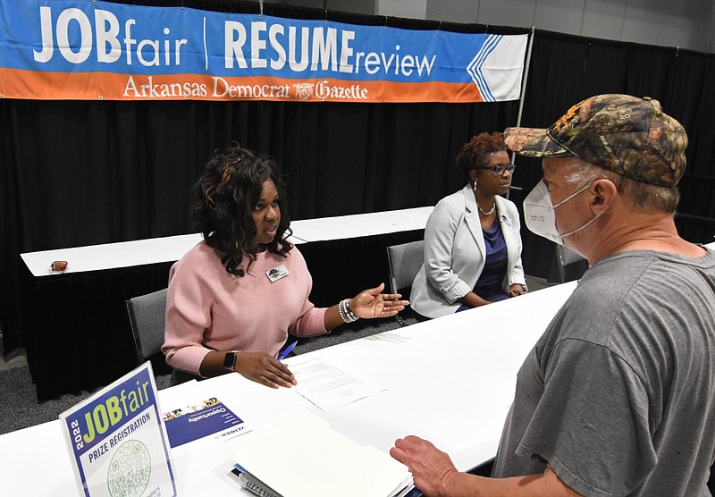 Gina Smith gives Dan Beard of Conway some advice on his resume during the job fair at the Statehouse Convention Center in Little Rock in this May 14, 2022 file photo. (Arkansas Democrat-Gazette/Staci Vandagriff)