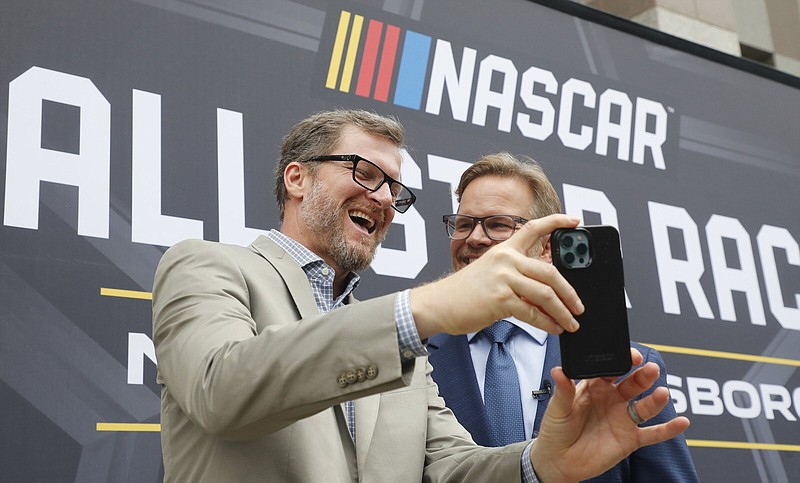 Dale Earnhardt Jr. (left) laughs with Speedway Motorsports President and CEO Marcus Smith as they record a video after a press conference announcing that the NASCAR All-Star Race will be held Sunday at North Wilkesboro (N.C.) Speedway.
(AP file photo)