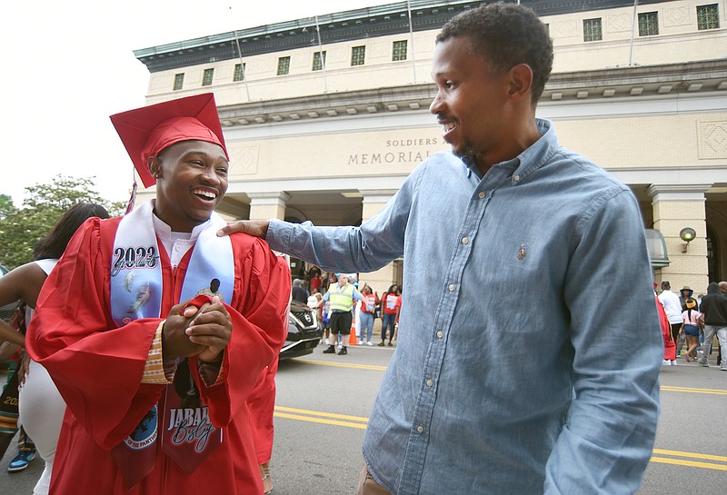 Staff photo by Matt Hamilton / Jabari Besley, left, talks with his father, Montrell Besley, on Saturday after the Brainerd High School graduation at Memorial Auditorium. The two had a scare on May 3 because of a false report of an active shooter at the school.