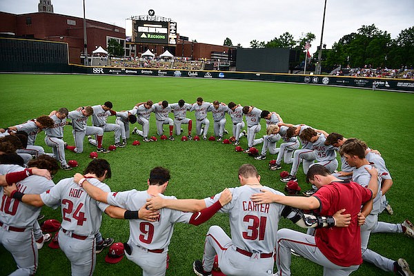 Arkansas players gather in prayer prior to a game against Vanderbilt on Friday, May 19, 2023, in Nashville, Tenn.