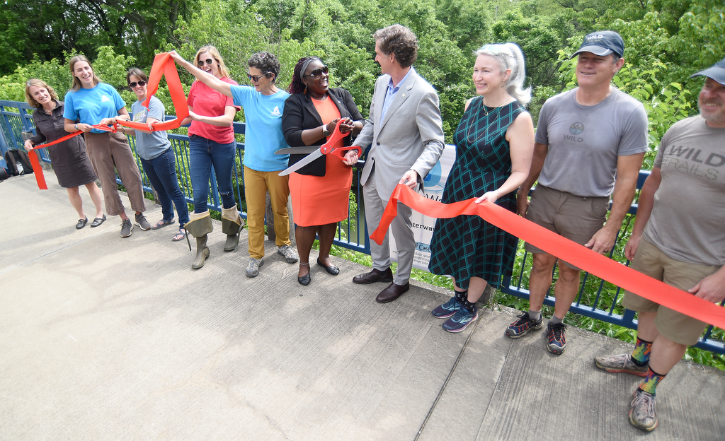 Staff photo by Matt Hamilton / Council Chair Raquetta Dotley and Mayor Tim Kelly hold the scissors during the ribbon cutting ceremony on the Tennessee River Walk on Tuesday, May 23, 2023.