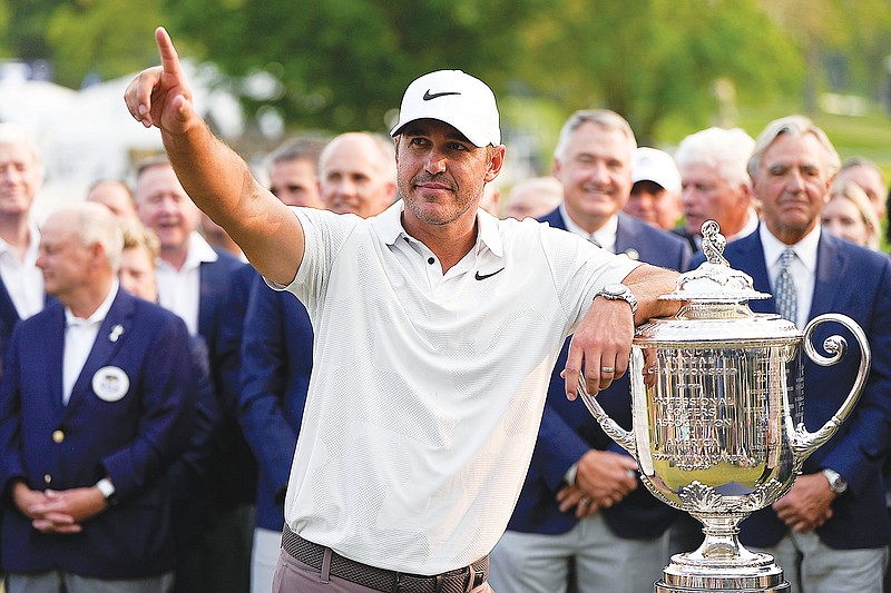 Brooks Koepka celebrates Sunday with the Wanamaker Trophy after winning the PGA Championship at Oak Hill Country Club in Pittsford, N.Y. (Associated Press)