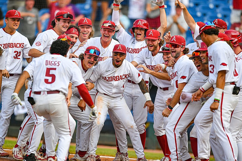 Arkansas players greet designated hitter Kendall Diggs (5) at the plate after Diggs hit a walk-off solo home run Wednesday during the 11th inning of the Razorbacks’ 6-5 win over the Texas A&M Aggies at the SEC Baseball Tournament at the Hoover Metropolitan Stadium in Hoover, Ala.
(NWA Democrat-Gazette/Hank Layton)