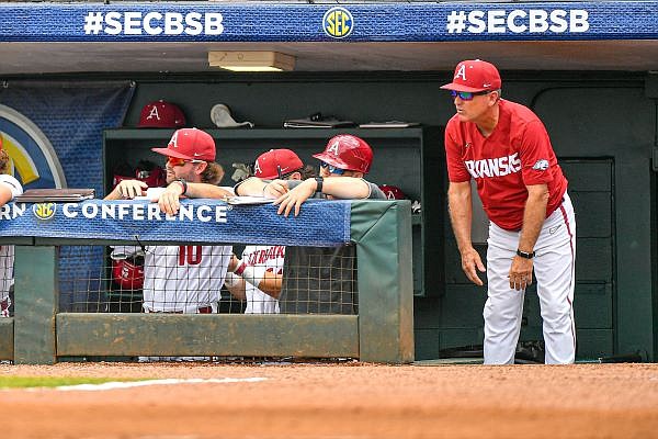 Arkansas head coach Dave Van Horn (right) reacts in the dugout, Wednesday, May 24, 2023, during the first inning of the Razorbacks’ 6-5 extra-innings win over the Texas A&M Aggies at the 2023 SEC Baseball Tournament at the Hoover Metropolitan Complex in Hoover, Ala. Visit nwaonline.com/photo for today's photo gallery....(NWA Democrat-Gazette/Hank Layton)