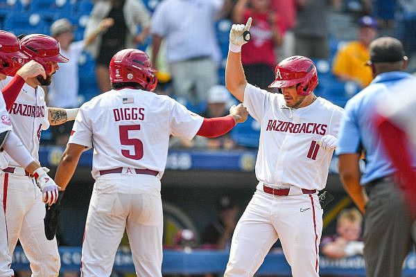 Arkansas left fielder Jared Wegner (11) celebrates with teammates after hitting a go-ahead grand slam, Wednesday, May 24, 2023, during the seventh inning against the Texas A&M Aggies at the 2023 SEC Baseball Tournament at the Hoover Metropolitan Complex in Hoover, Ala. Visit nwaonline.com/photo for today's photo gallery....(NWA Democrat-Gazette/Hank Layton)