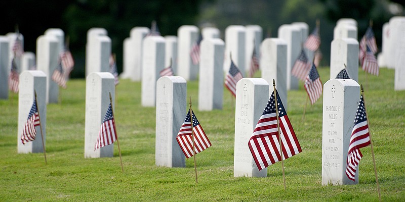 Staff photo by Matt Hamilton / Flags adorn graves at the Chattanooga National Cemetery on Wednesday, May 24, 2023. The process of planting the over 50,000 flags began on Wednesday and will continue through Saturday. A Memorial Day ceremony will be held Monday, May 29, 2023, at 11 a.m. in the Cemetery.