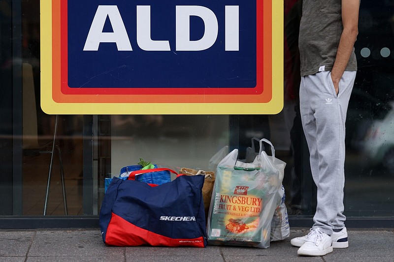 A customer waits outside an Aldi Stores Ltd. supermarket in London.
(Bloomberg News WPNS/Hollie Adams)