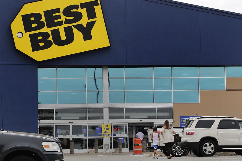 A woman walks with a child to the Best Buy store at the Mall of New Hampshire in Manchester, N.H.
(AP)