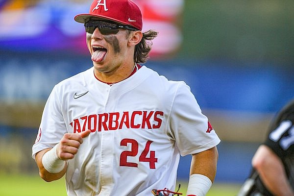 Arkansas second baseman Peyton Holt (24) celebrates after successfully faking a 6-4-3 double play and instead throwing out LSU designated hitter Hayden Travinski (not picutred) at third base, Thursday, May 25, 2023, during the sixth inning of the Razorbacks’ 5-4 win over the Tigers at the 2023 SEC Baseball Tournament at the Hoover Metropolitan Complex in Hoover, Ala.