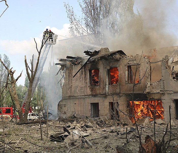 Firefighters hose down a building housing psychology and veterinary clinics Friday in Dnipro in central Ukraine after a Russian strike. Authorities said two people were killed and 30 wounded. Russia reported another attack in its southern Belgorad region.
(AP/State Emergency Service of Ukraine)