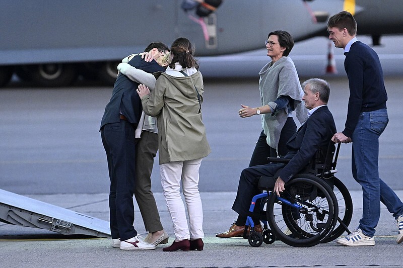 Belgium’s Olivier Vandecasteele (left) is greeted by his family after landing at Melsbroek military airport Friday in Melsbroek, Belgium.
(AP/Didier Lebrun)