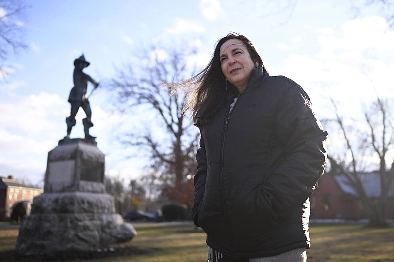 FILE — Beth Caruso, author and co-founder of the CT Witch Trial Exoneration Project, which was created to clear the names of the accused, stands on the Palisado Green in Windsor, Conn., Jan. 24, 2023. With distant family members looking on, Connecticut senators voted Thursday, May 25, 2023, to absolve the 12 women and men convicted of witchcraft -- 11 of whom were executed — more than 370 years ago and apologize for the “miscarriage of justice” that occurred over a dark 15-year-period of the state's colonial history. (AP Photo/Jessica Hill, File)