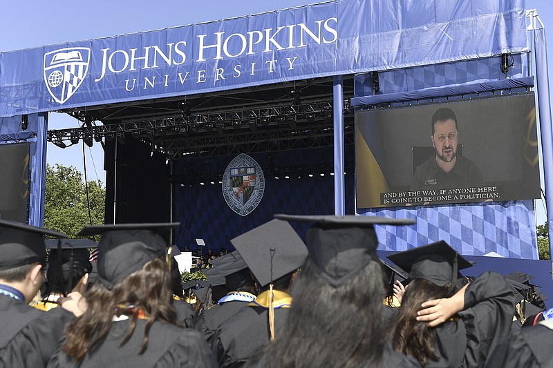 In this handout photo released by Johns Hopkins University, Ukrainian President Volodymyr Zelenskyy addresses the graduating class of Johns Hopkins University via livestream from Ukraine, Thursday, May 25, 2023, in Baltimore, Md. (Will Kirk/Johns Hopkins University via AP)