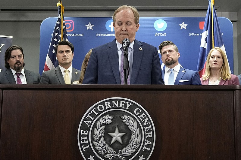 Texas state Attorney General Ken Paxton, center, flanked by his staff, makes a statement at his office in Austin, Texas, Friday, May 26, 2023. (AP/Eric Gay)