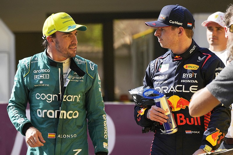 Fernando Alonso (left) talks with Max Verstappen at the end of the Formula One qualifying session Saturday at the Monaco racetrack in Monaco. (The Associated Press)