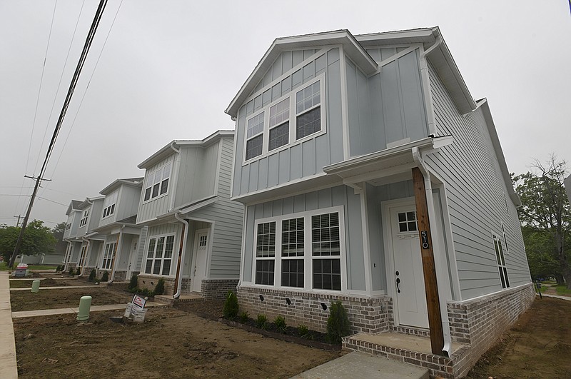 Town homes are shown along Persimmon Street in Rogers on May 16. Having liberal land use regulations can help cities build more housing, but zoning alone will not solve a region’s housing crisis, urban planning experts say.
(NWA Democrat-Gazette/Charlie Kaijo)