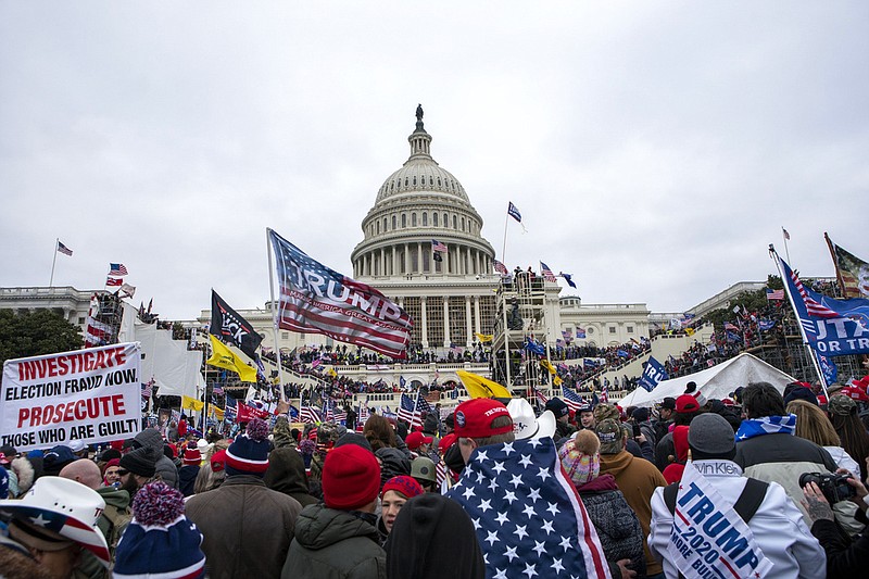 FILE - Insurrectionists loyal to President Donald Trump rally at the U.S. Capitol in Washington on Jan. 6, 2021. A growing number of Capitol rioters are facing hefty fines on top of prison sentences at their sentencing hearings.