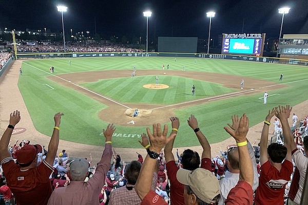 Arkansas fans call the Hogs Friday, April 14, 2023, during the seventh-inning stretch of the Razorbacks’ game with Tennessee at Baum-Walker Stadium in Fayetteville.