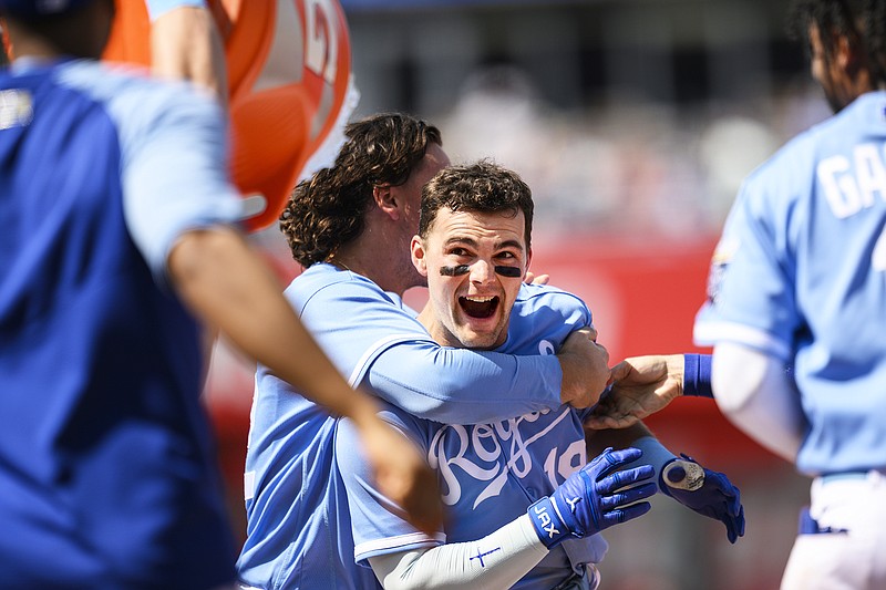 Michael Massey is mobbed by his Royals teammates and has a cooler of water dumped on him after hitting a walkoff single in the bottom of the ninth inning of Sunday afternoon's game against the Nationals at Kauffman Stadium in Kansas City. (Associated Press)