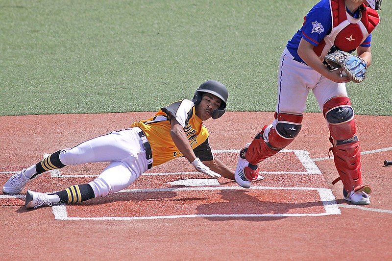 St. Elizabeth’s Noah Chipman slides across home plate to score a run during the third inning of Monday morning’s Class 1 state semifinal game against Cooter at Sky Bacon Stadium in Ozark. (Greg Jackson/News Tribune)