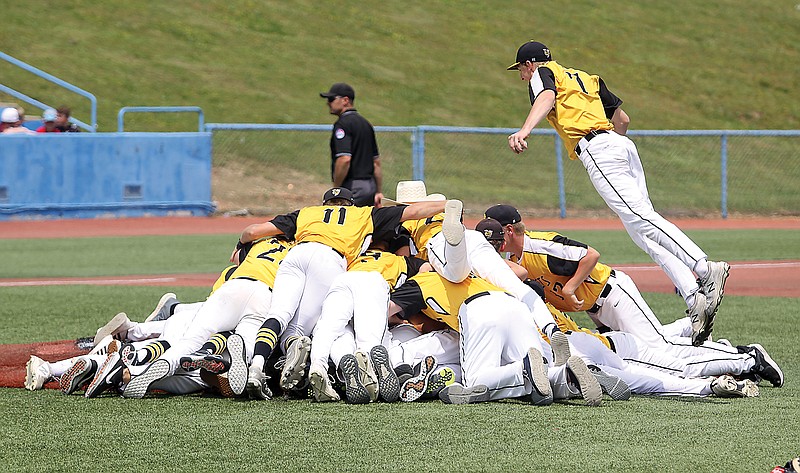 Gavin Williams jumps onto his St. Elizabeth teammates and joins the dogpile following the final out of Tuesday afternoon's Class 1 state championship game against Platte Valley at Sky Bacon Stadium in Ozark. (Greg Jackson/News Tribune)