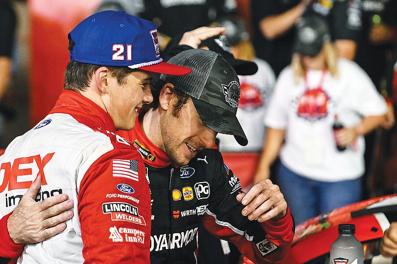 Ryan Blaney (right) is embraced by Harrison Burton after winning the NASCAR Cup Series race Monday at Charlotte Motor Speedway in Concord, N.C. (Associated Press)