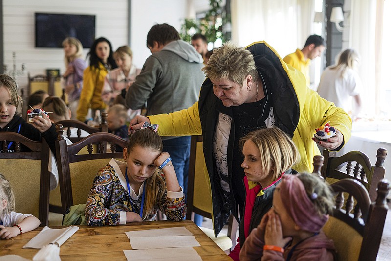 Nina Poliakova speaks to her foster daughter Olha Hinkina at the recovery camp for children and their mothers affected by the war near Lviv, Ukraine, Wednesday, May 3, 2023. A generation of Ukrainian children have seen their lives upended by Russia's invasion of their country. Hundreds of kids have been killed. For the survivors, the wide-ranging trauma is certain to leave psychological scars that will follow them into adolescence and adulthood. UNICEF says an estimated 1.5 million Ukrainian children are at risk of mental health issues. (AP Photo/Hanna Arhirova)
