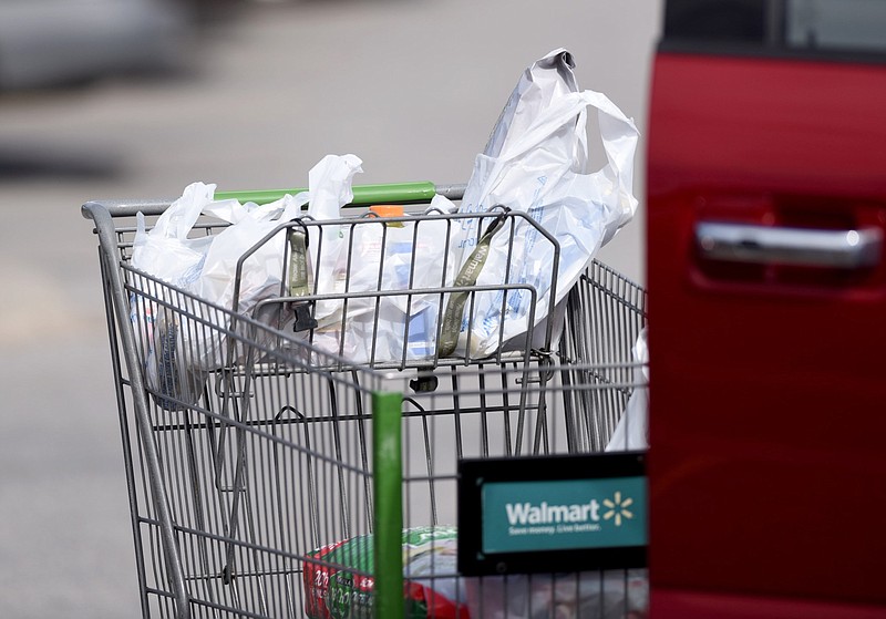 Groceries from the Walmart Neighborhood Market on Martin Luther King Drive in Fayetteville are carried in plastic bags in this Feb. 27, 2020 file photo. (NWA Democrat-Gazette/David Gottschalk)