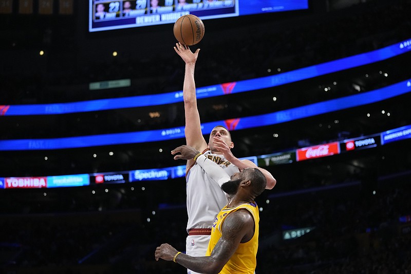 Denver Nuggets center Nikola Jokic shoots over Los Angeles Lakers forward LeBron James in the second half of Game 4 of the NBA basketball Western Conference Final series Monday, May 22, 2023, in Los Angeles. (AP Photo/Ashley Landis)