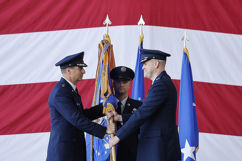 Maj. Gen. Corey Martin (left), commander of the 18th Air Force, hands the 19th Airlift Wing guidon to Col. Denny Davies (right), as he takes command of the 19th Airlift wing during a change of command ceremony on Thursday, June 1, 2023, at Little Rock Air Force Base in Jacksonville. .More photos at www.arkansasonline.com/62command/.(Arkansas Democrat-Gazette/Thomas Metthe)